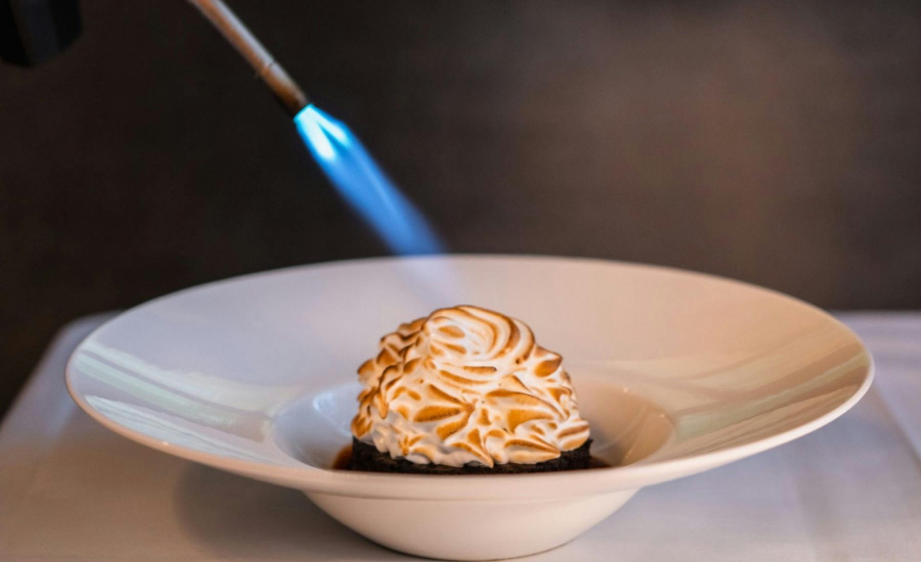 a Baked Alaska being tourched